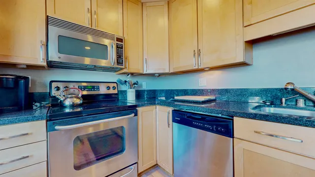 a view of a room with furniture and a mirror