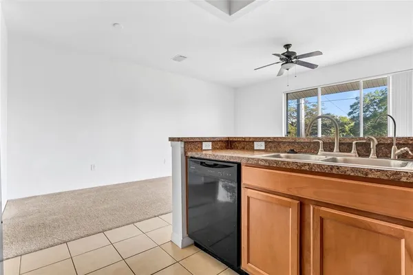 a kitchen with granite countertop a sink and a stove with wooden floor