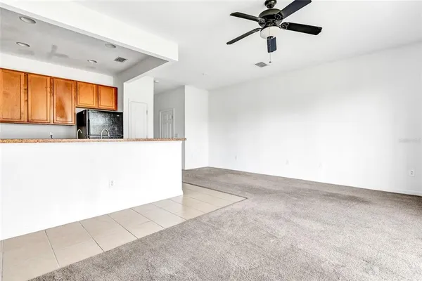 a living room with a ceiling fan and a window