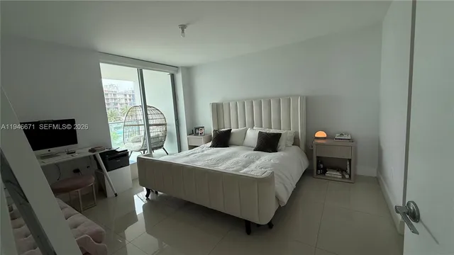 a bedroom with a bed and a tv