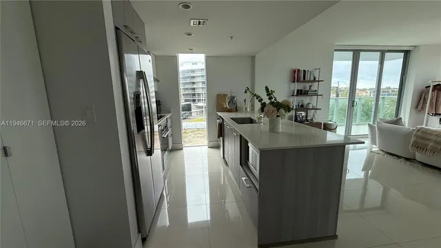 a kitchen with sink and refrigerator