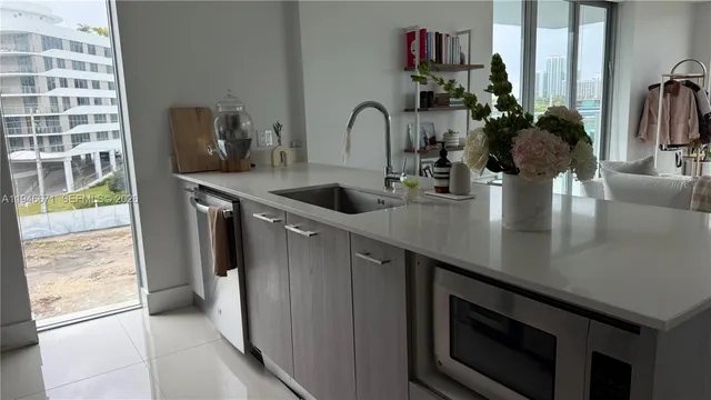 a kitchen with a sink and a stove top oven