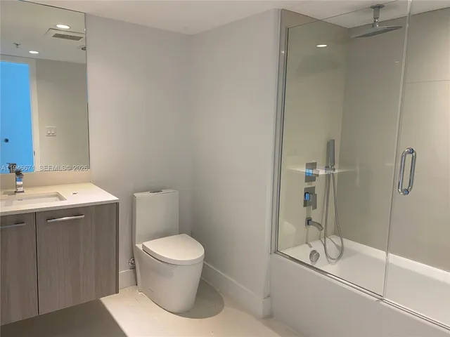 a bathroom with a toilet sink and shower