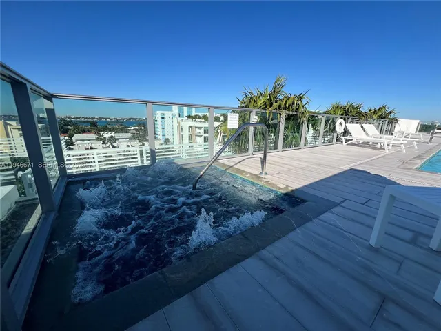 a swimming pool with outdoor seating