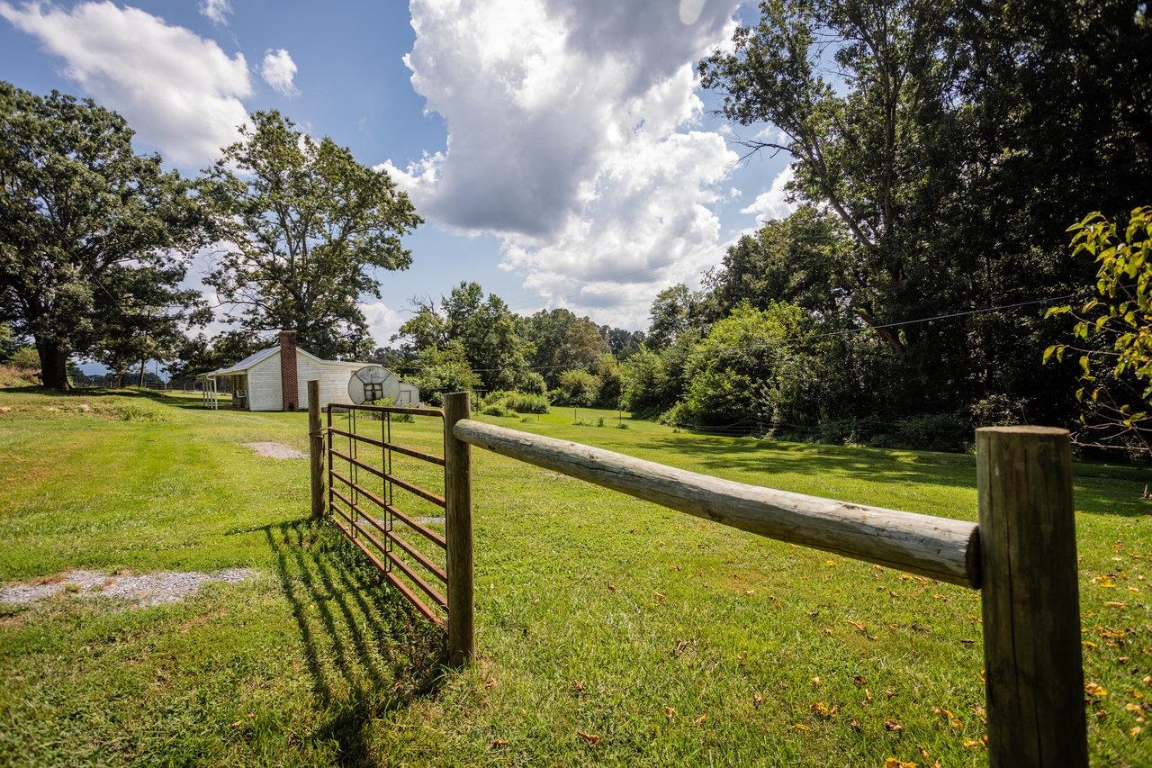 1557 Rinacas Corner Road Shenandoah, VA 22849 - Photo 12 of 32 a view of a lake with a floor to ceiling window next to a yard