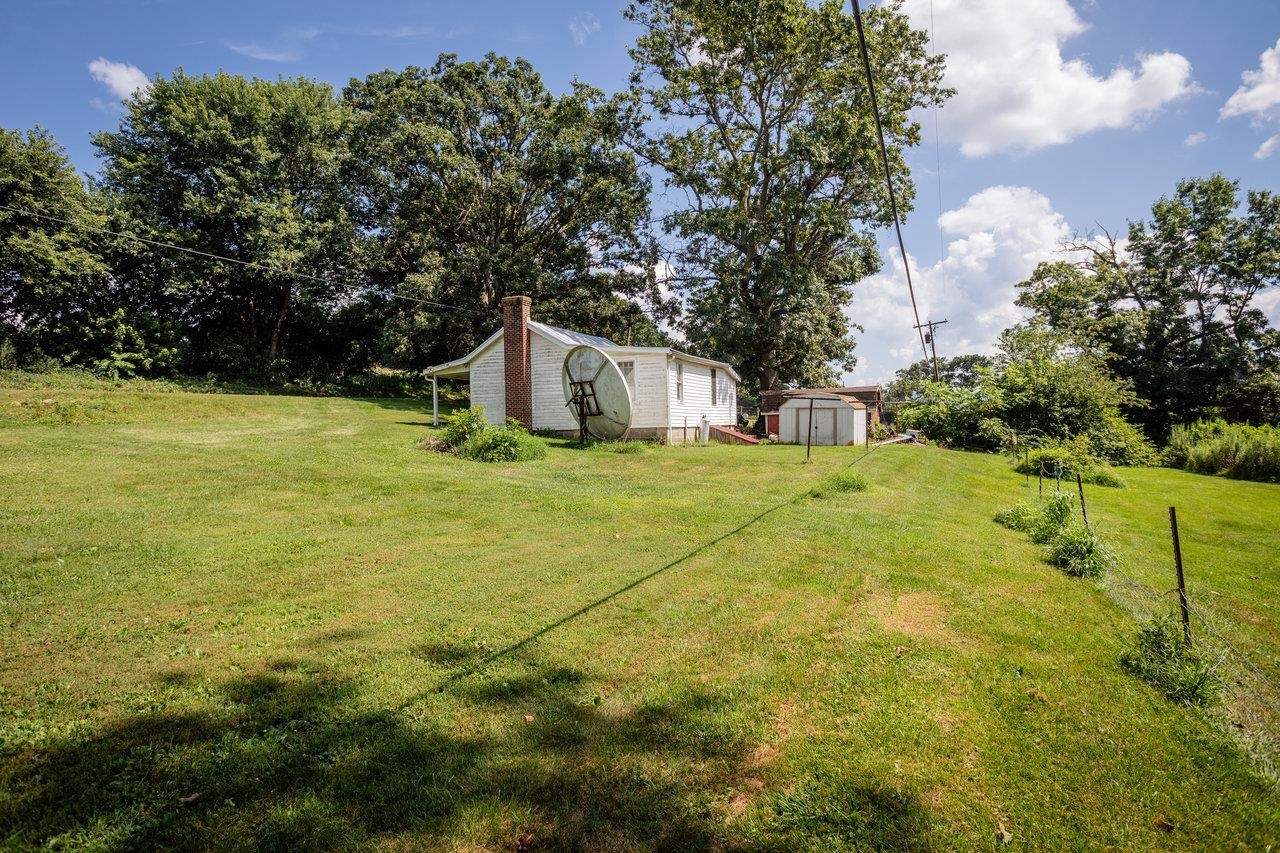 1557 Rinacas Corner Road Shenandoah, VA 22849 - Photo 15 of 32 a view of a big yard with large trees