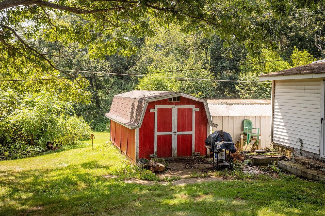 1557 Rinacas Corner Road Shenandoah, VA 22849 - Photo 8 of 32 a view of a barn with big yard and large trees