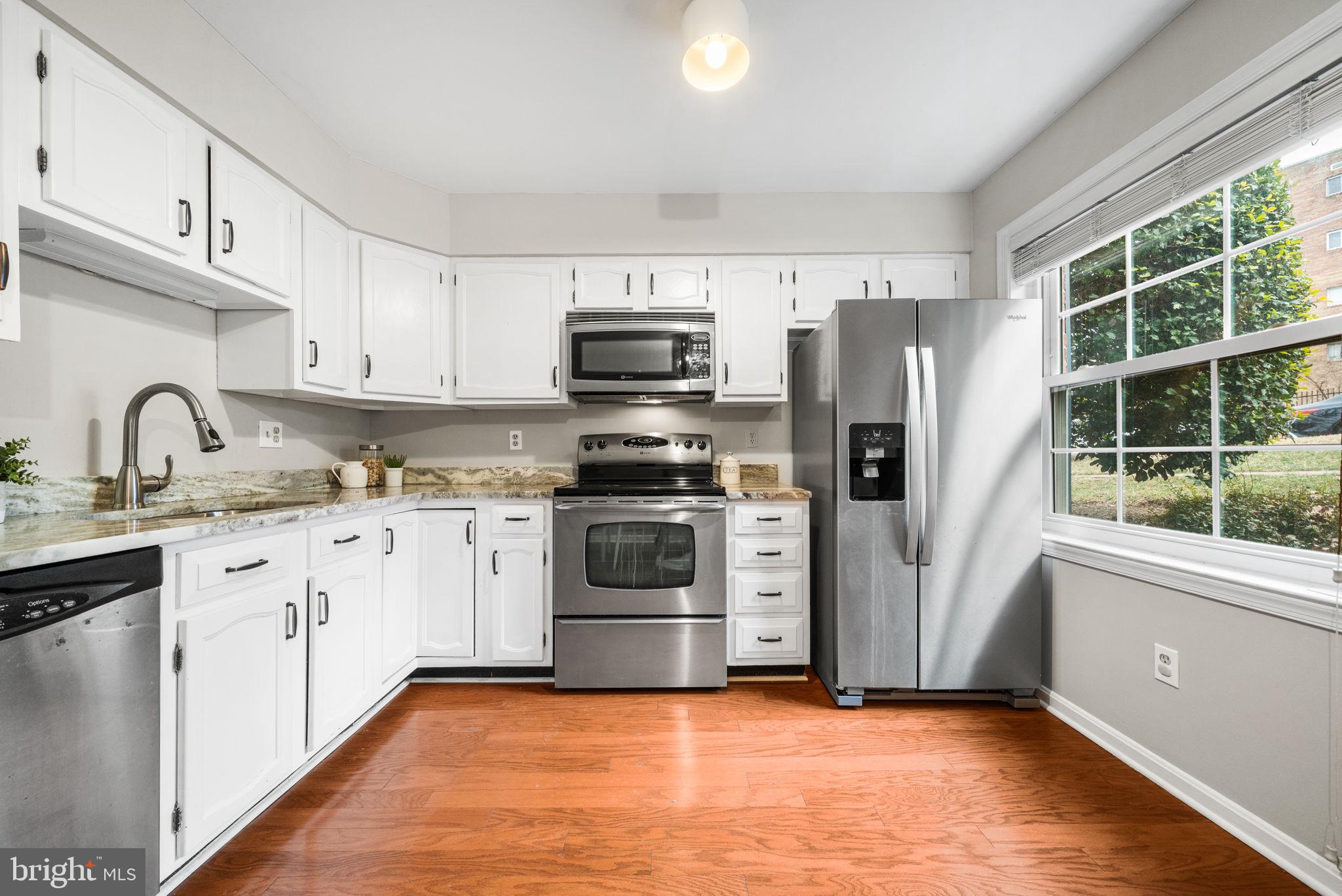 4931 7th Road South, Unit 4931 Arlington, VA 22204 - Photo 13 of 25 a kitchen with granite countertop a refrigerator and a stove top oven