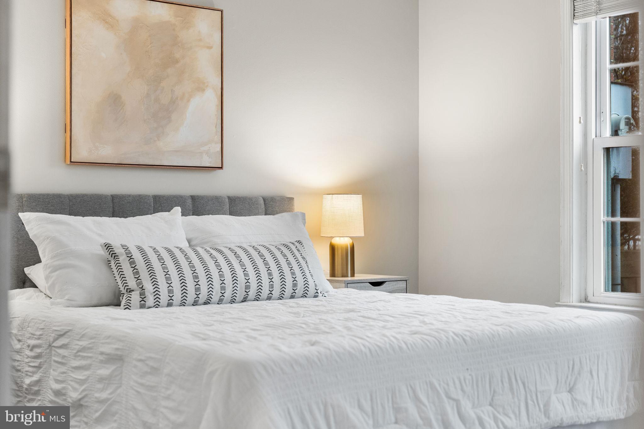 4931 7th Road South, Unit 4931 Arlington, VA 22204 - Photo 15 of 25 a bedroom with a bed and a painting on the wall