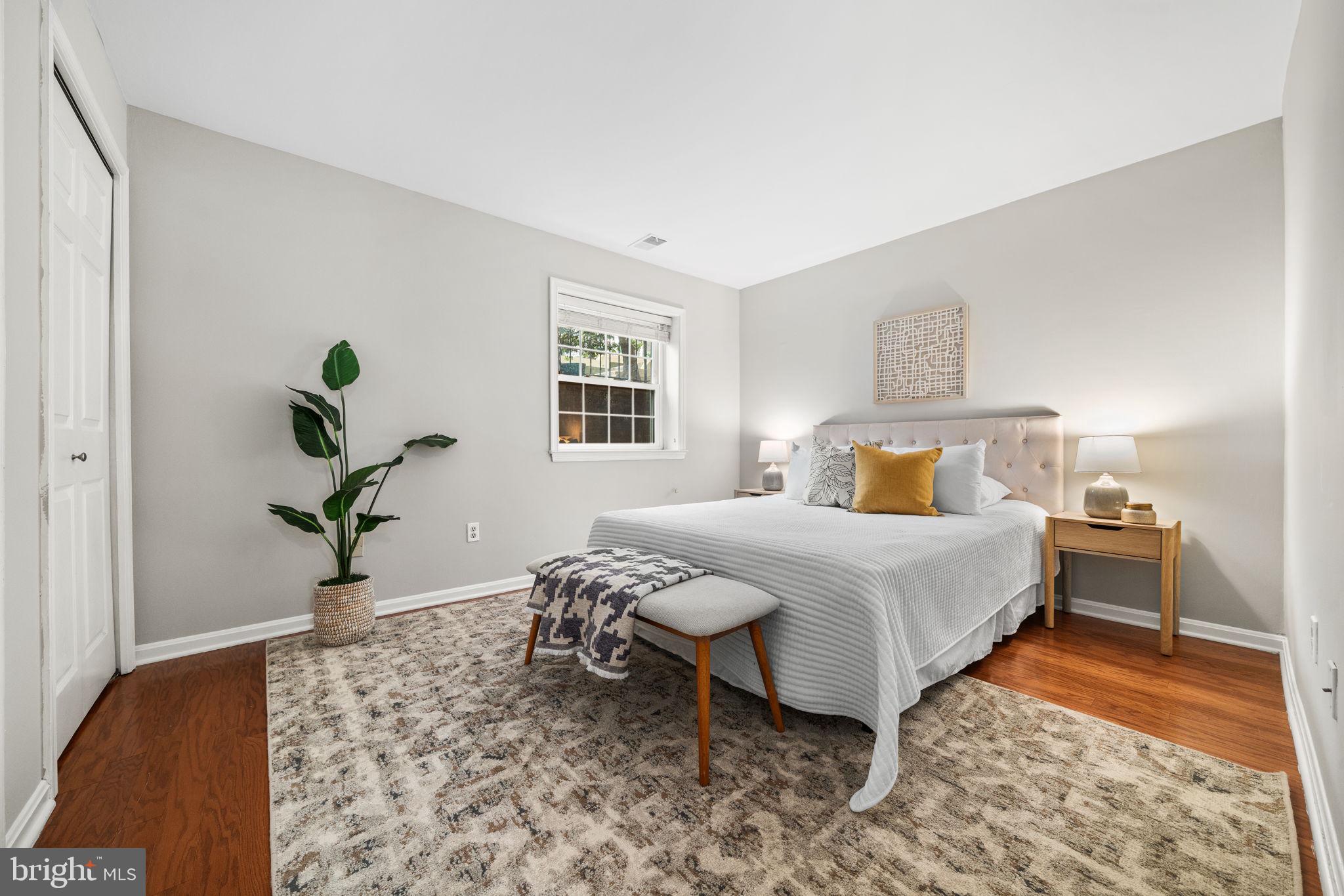 4931 7th Road South, Unit 4931 Arlington, VA 22204 - Photo 18 of 25 a bedroom with a bed and wooden floor
