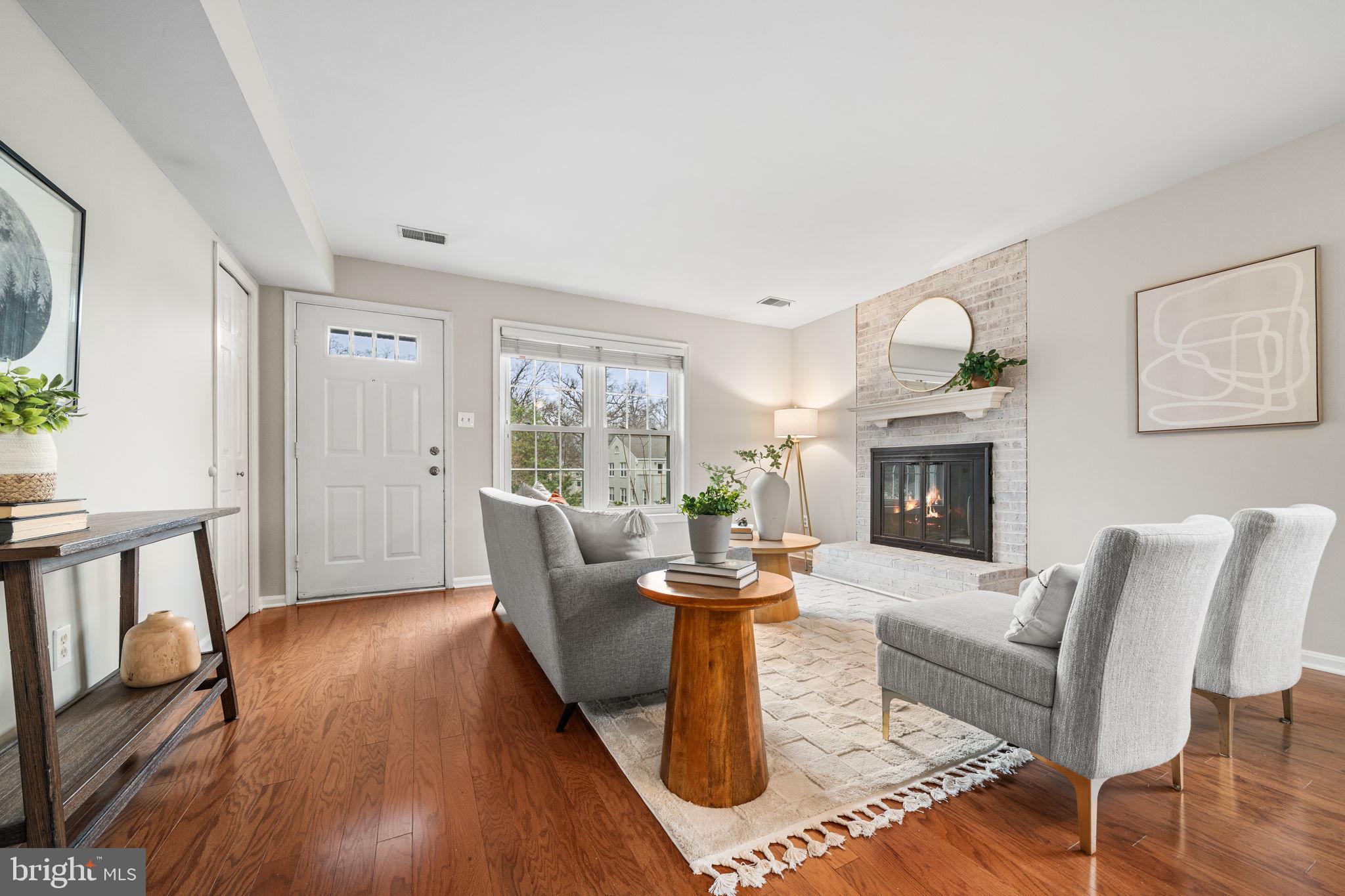 4931 7th Road South, Unit 4931 Arlington, VA 22204 - Photo 5 of 25 a living room with furniture a fireplace and a large window