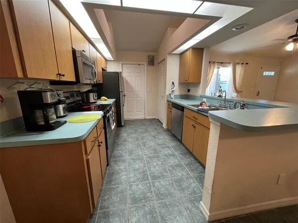 a kitchen with stainless steel appliances granite countertop a sink a stove and a refrigerator