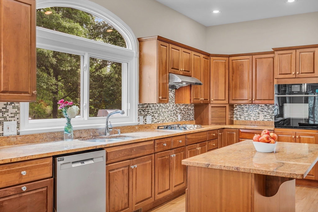 7 Apple Ridge Drive Natick, MA 01760 - Photo 2 of 42 a kitchen with stainless steel appliances wooden cabinets a sink and a large window