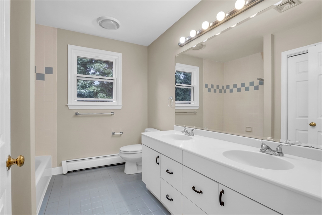7 Apple Ridge Drive Natick, MA 01760 - Photo 21 of 42 a bathroom with double vanity sink a mirror and a toilet