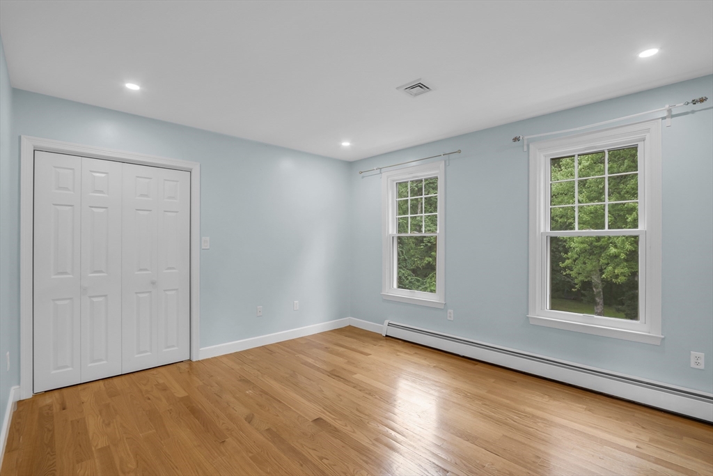 7 Apple Ridge Drive Natick, MA 01760 - Photo 22 of 42 an empty room with wooden floor and windows