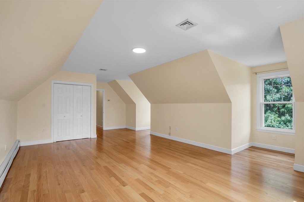 7 Apple Ridge Drive Natick, MA 01760 - Photo 25 of 42 a view of an empty room with wooden floor and a window