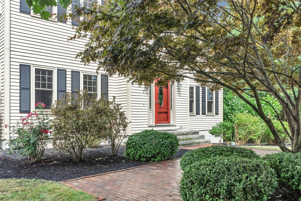 7 Apple Ridge Drive Natick, MA 01760 - Photo 32 of 42 a front view of a house with a yard and potted plants