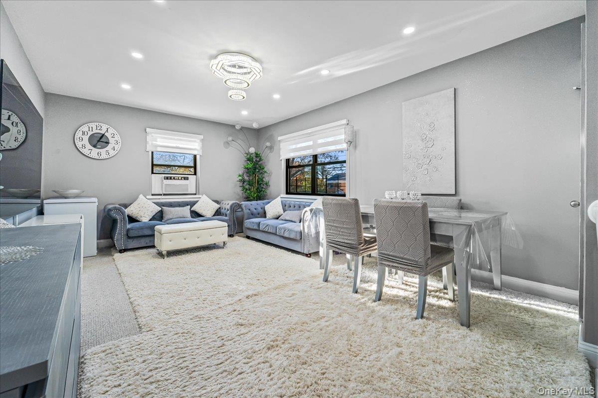 217-08 73rd Avenue, Unit 383A2 Queens, NY 11364 - Photo 1 of 24 a living room with furniture and a large mirror