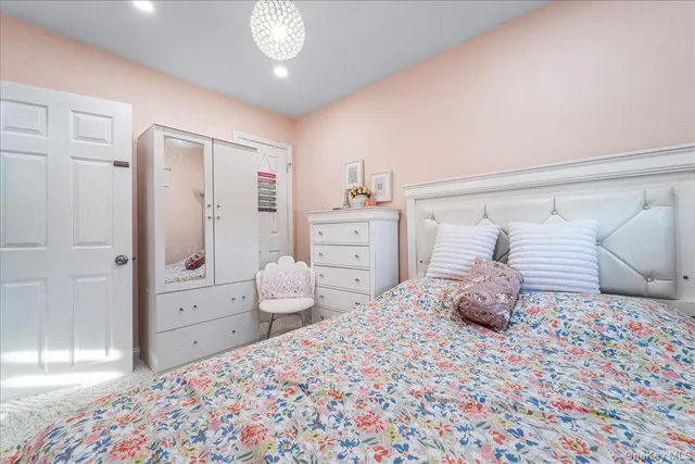 a bedroom with a bed and cabinets