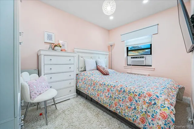 a bedroom with a bed a table and chair