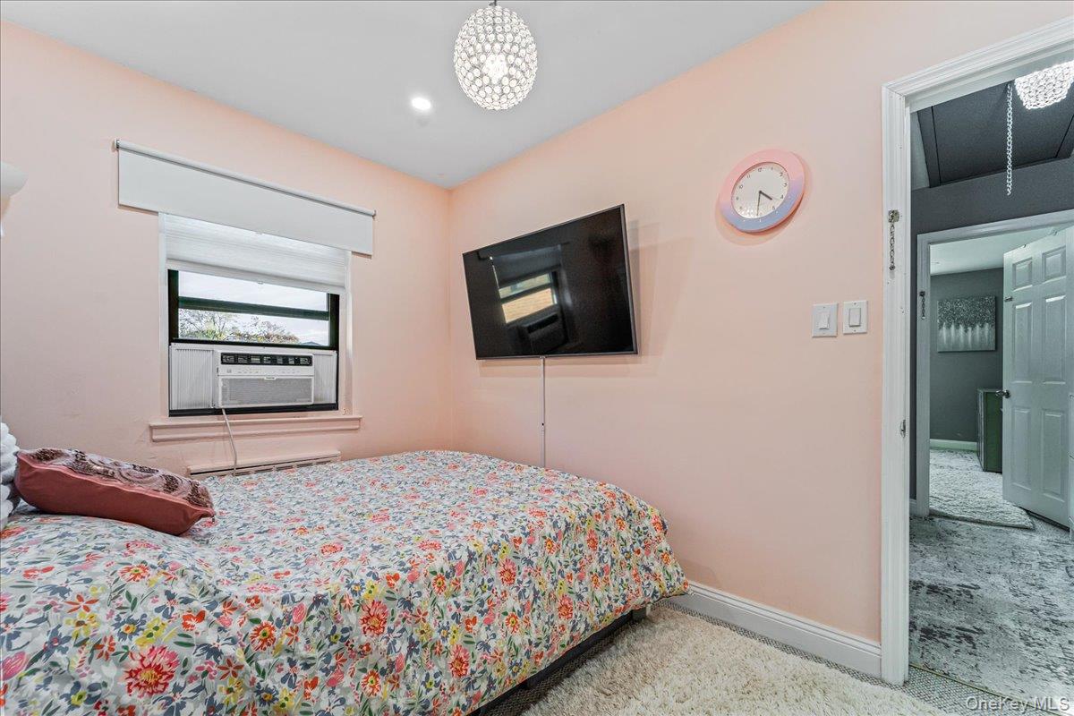 217-08 73rd Avenue, Unit 383A2 Queens, NY 11364 - Photo 13 of 24 a bedroom with a bed and a television