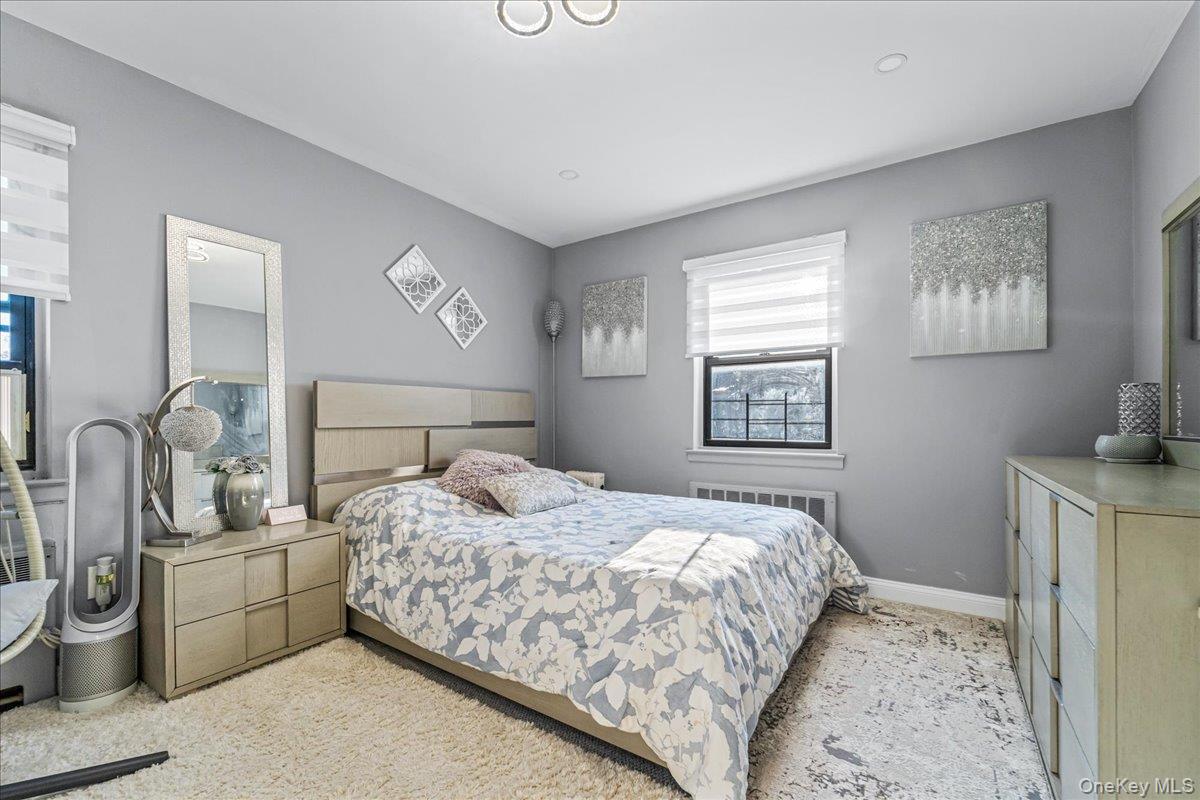 217-08 73rd Avenue, Unit 383A2 Queens, NY 11364 - Photo 15 of 24 a bedroom with a bed and a dresser