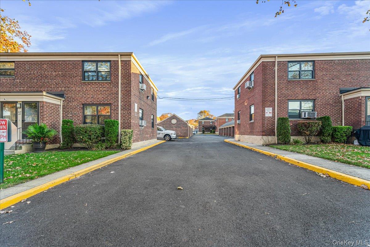 217-08 73rd Avenue, Unit 383A2 Queens, NY 11364 - Photo 19 of 24 a view of a brick house with a yard