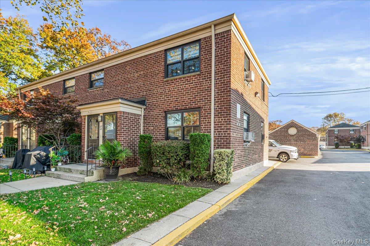 217-08 73rd Avenue, Unit 383A2 Queens, NY 11364 - Photo 2 of 24 a view of a house with a yard and table and chairs in patio