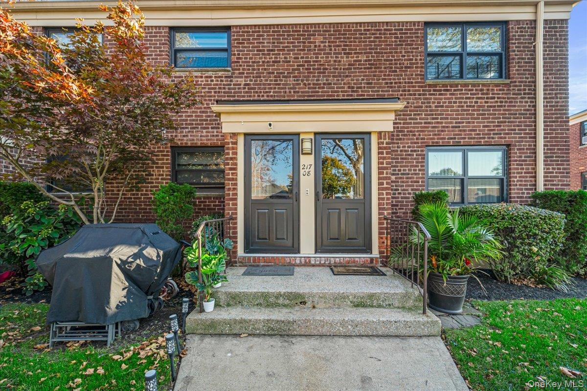 217-08 73rd Avenue, Unit 383A2 Queens, NY 11364 - Photo 3 of 24 a front view of a house with garden