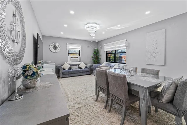 a living room with furniture potted plant and window