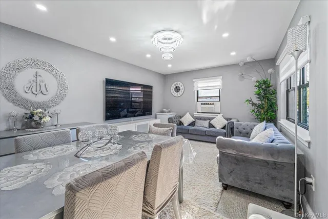 a living room with furniture potted plant and a large mirror