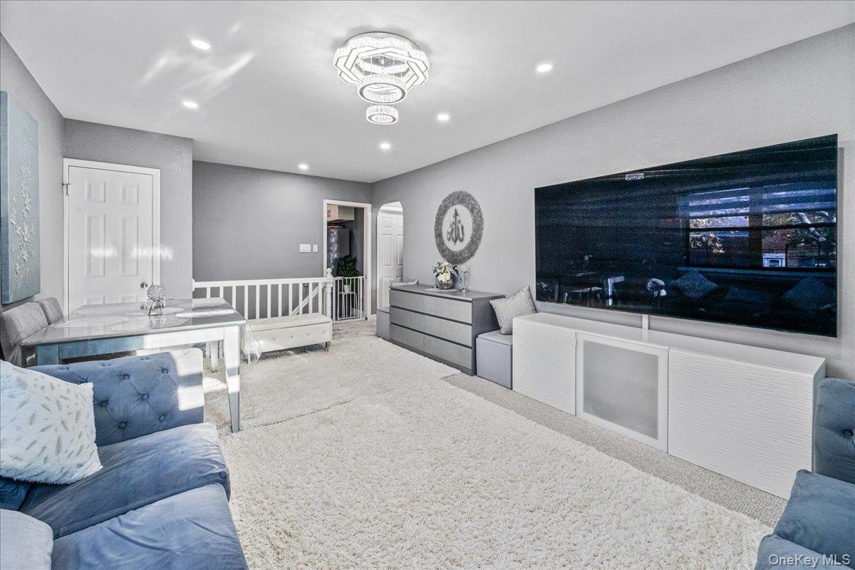 217-08 73rd Avenue, Unit 383A2 Queens, NY 11364 - Photo 6 of 24 a living room with furniture and a flat screen tv