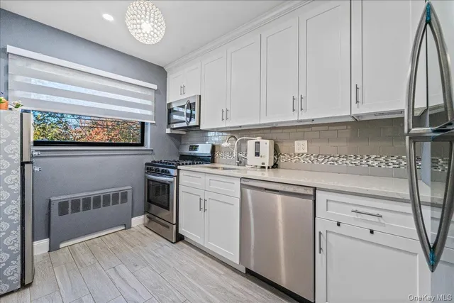 a kitchen with white cabinets and white appliances