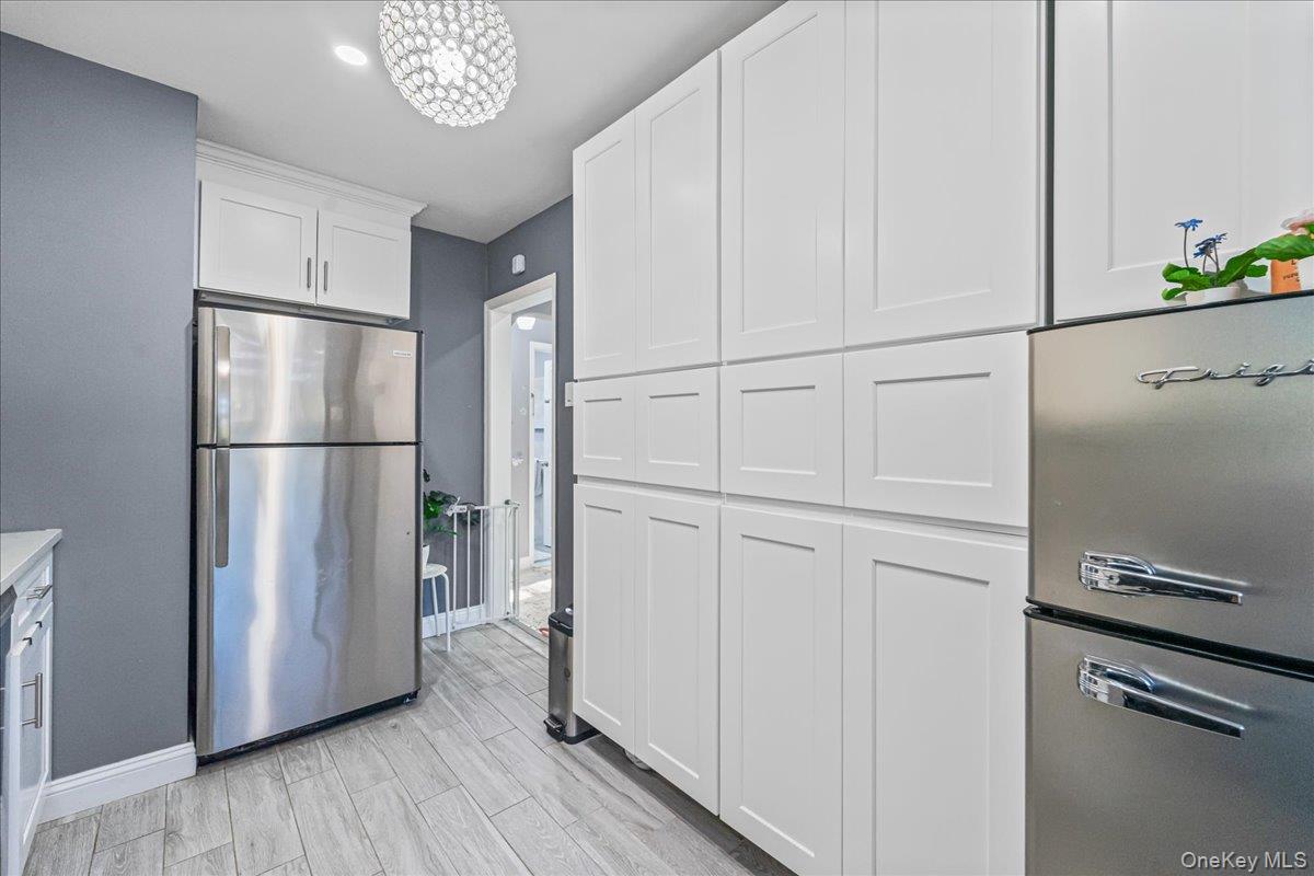 217-08 73rd Avenue, Unit 383A2 Queens, NY 11364 - Photo 10 of 24 a kitchen with stainless steel appliances a refrigerator and a refrigerator