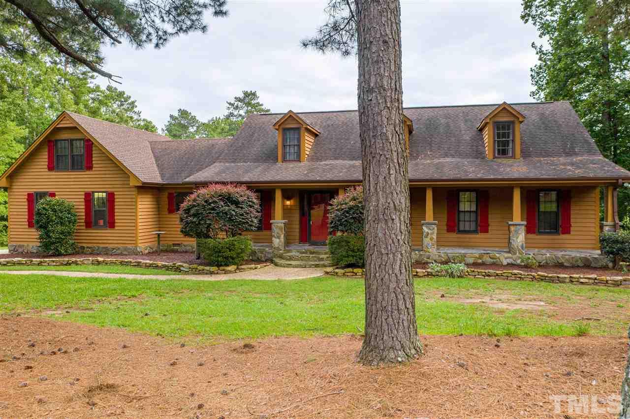 7010 Farmdale Road Raleigh, NC 27610 - Photo 1 of 30 a front view of a house with garden