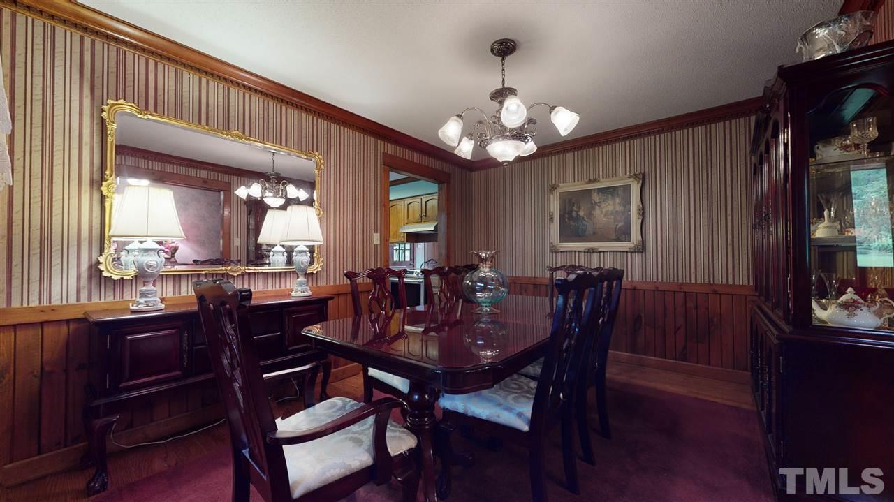 7010 Farmdale Road Raleigh, NC 27610 - Photo 12 of 30 a view of a dining room with furniture and a chandelier