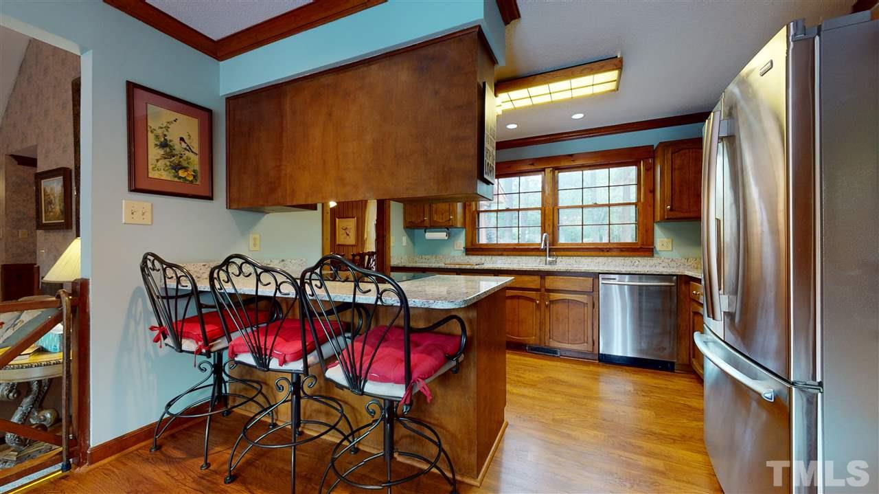 7010 Farmdale Road Raleigh, NC 27610 - Photo 13 of 30 a view of a dining room with furniture window and wooden floor