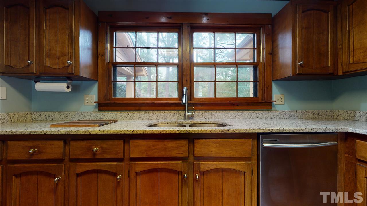 7010 Farmdale Road Raleigh, NC 27610 - Photo 14 of 30 a kitchen with granite countertop cabinets sink and window