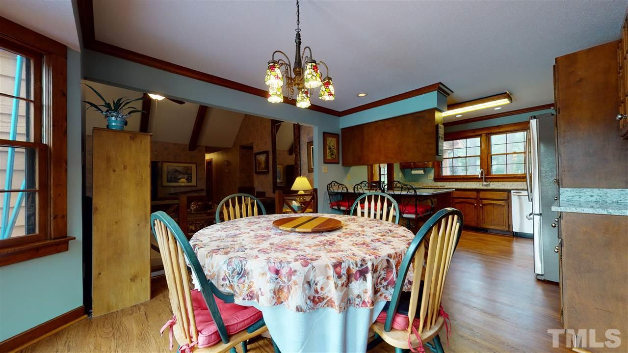 7010 Farmdale Road Raleigh, NC 27610 - Photo 16 of 30 a view of a dining room with furniture and wooden floor