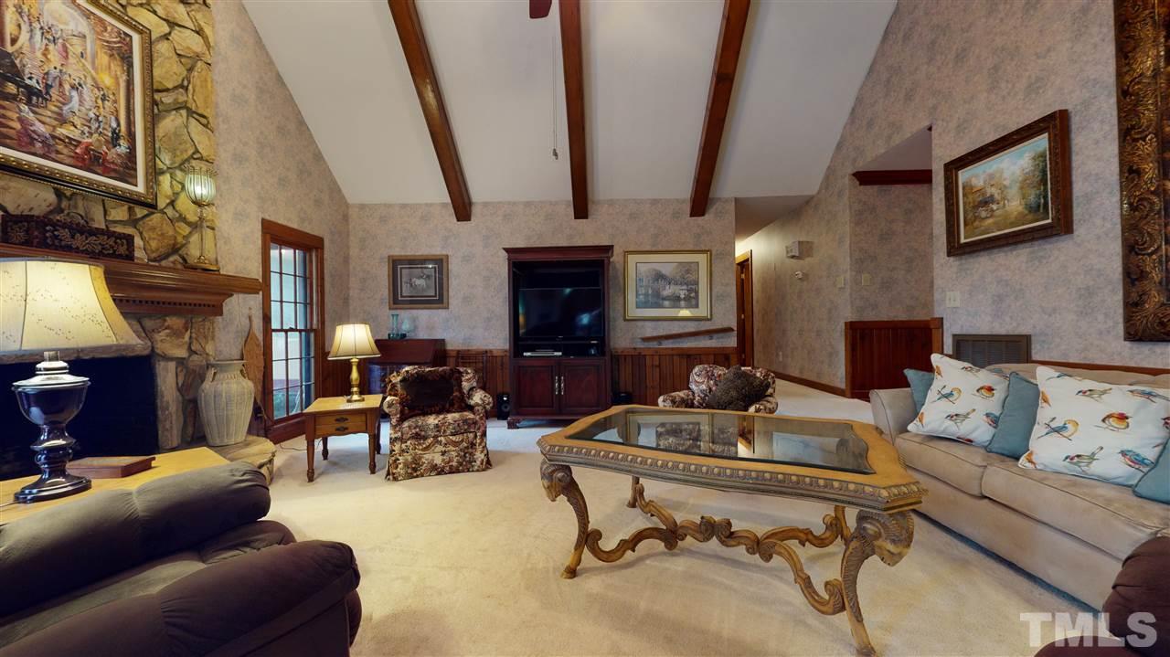 7010 Farmdale Road Raleigh, NC 27610 - Photo 19 of 30 a living room with furniture and a fireplace