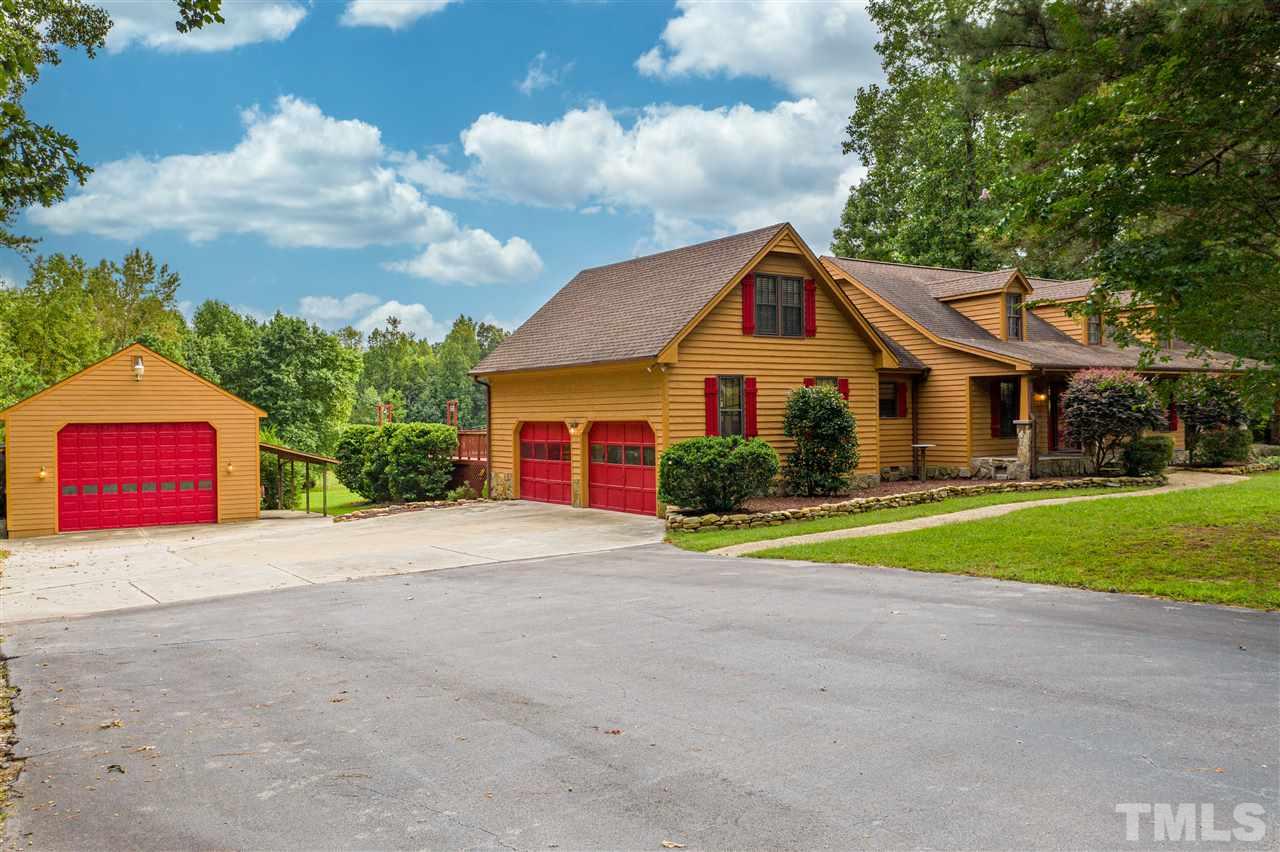 7010 Farmdale Road Raleigh, NC 27610 - Photo 3 of 30 a front view of a house with a yard and garage