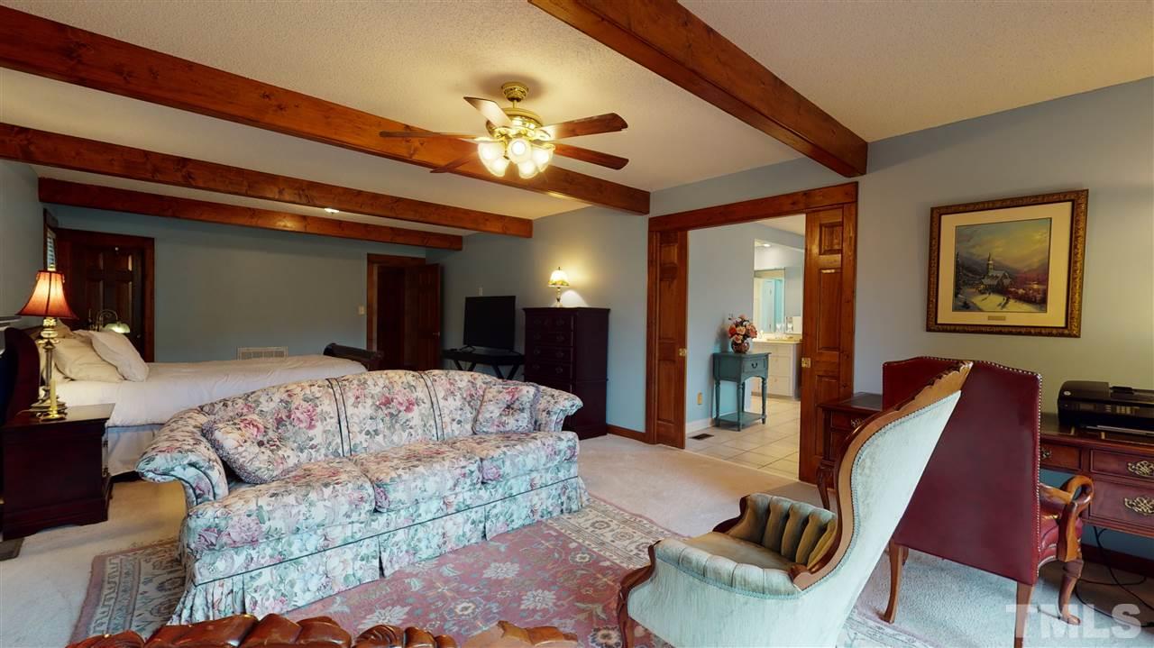 7010 Farmdale Road Raleigh, NC 27610 - Photo 22 of 30 a living room with furniture and a chandelier