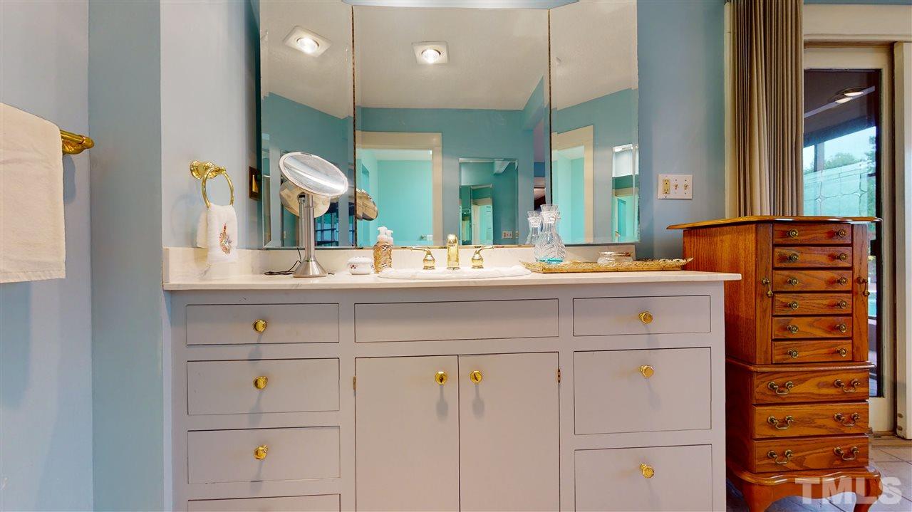 7010 Farmdale Road Raleigh, NC 27610 - Photo 24 of 30 a bathroom with a sink vanity and mirror