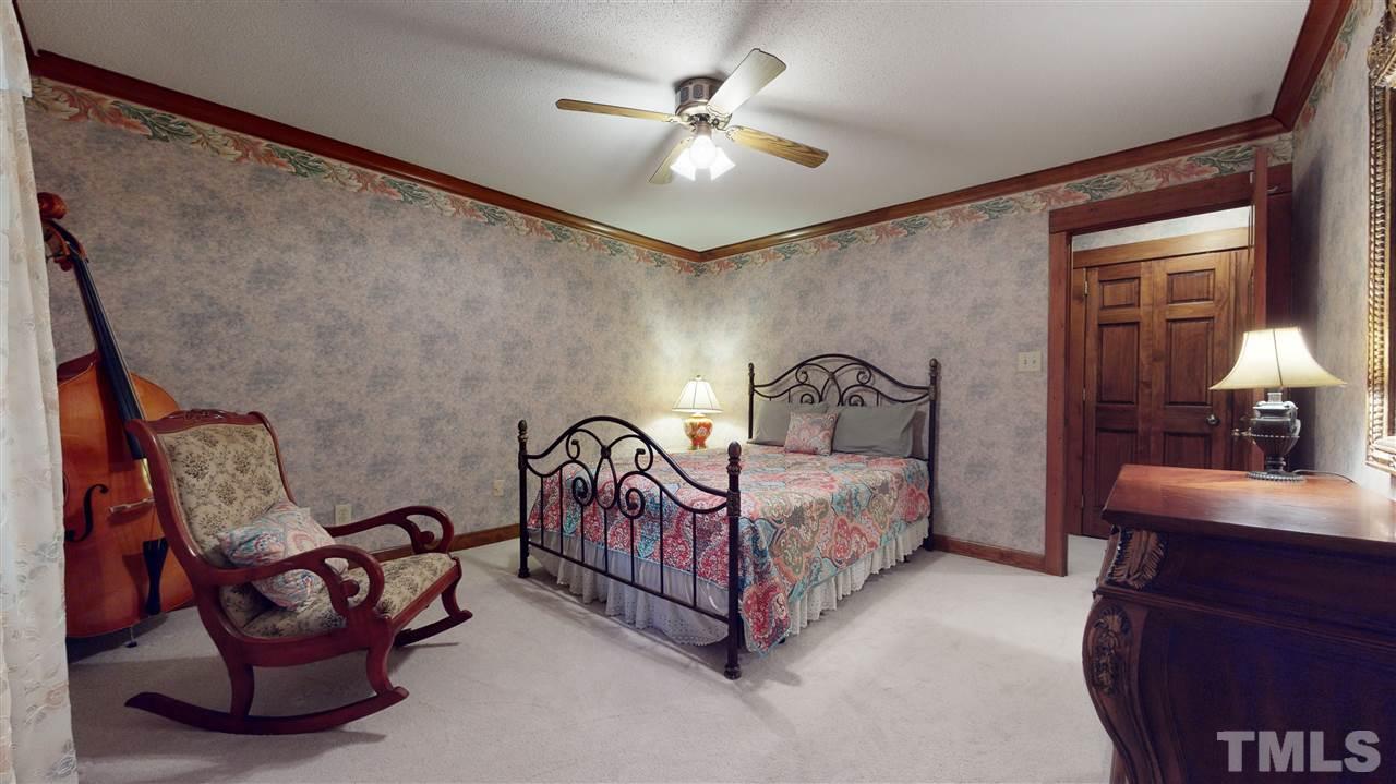 7010 Farmdale Road Raleigh, NC 27610 - Photo 27 of 30 a bedroom with furniture and a ceiling fan