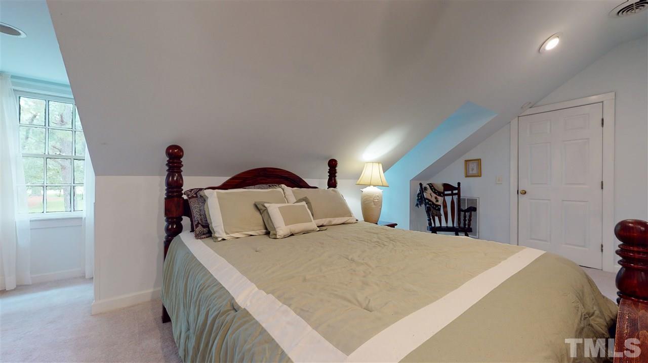 7010 Farmdale Road Raleigh, NC 27610 - Photo 28 of 30 a bedroom with a bed and a large window
