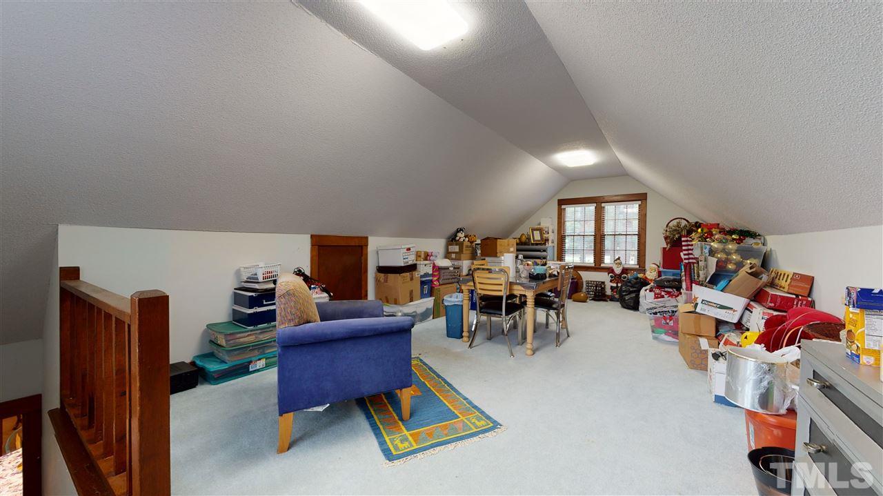 7010 Farmdale Road Raleigh, NC 27610 - Photo 29 of 30 a living room with furniture and a dining table with wooden floor
