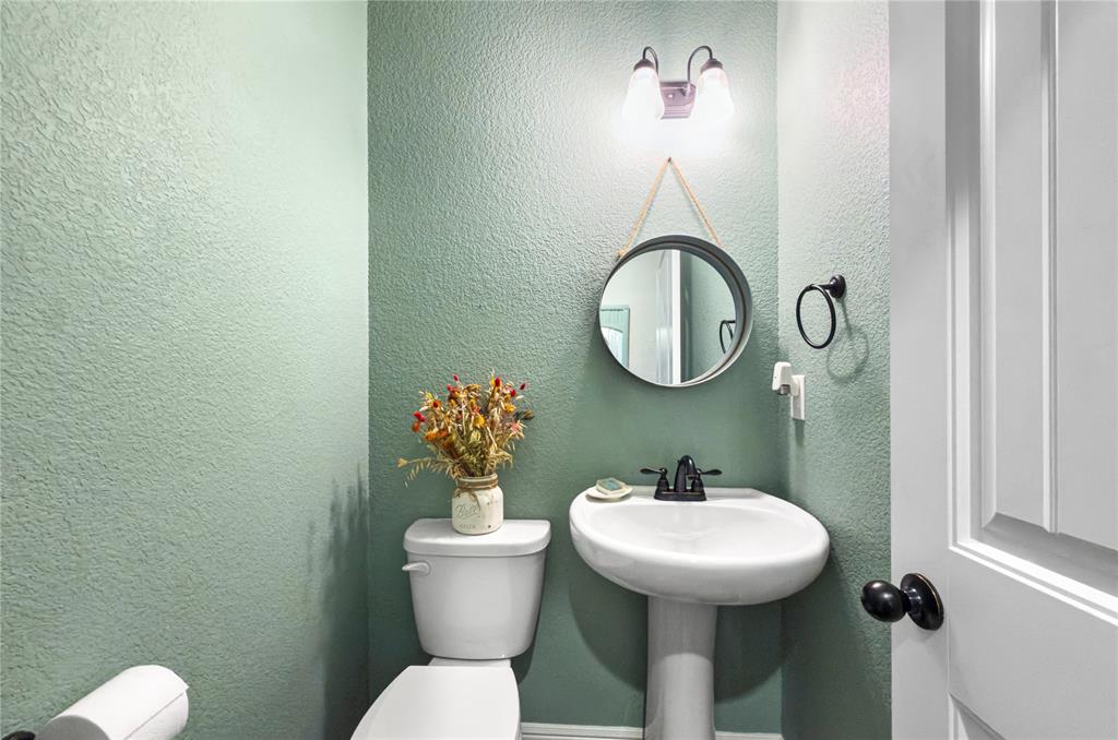 6093 Farm To Market Road 730 North Decatur, TX 76234 - Photo 18 of 28 a bathroom with a toilet sink and mirror