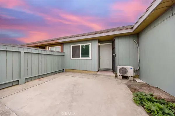a backyard of a house with yard and furniture
