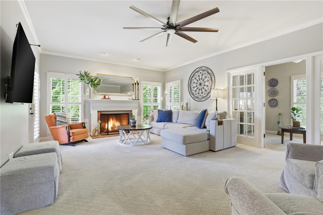 103 5 Knoll Court Anderson, SC 29621 - Photo 4 of 33 A comforting glow emanates from the fireplace, warming a spacious living area with refined architectural details.