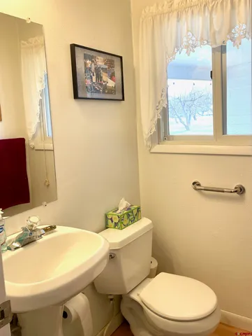 a bathroom with a sink mirror and toilet